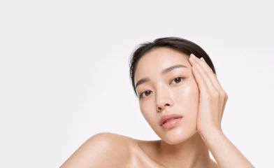 Woman gently resting a hand against her face
